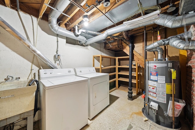 washroom with light floors, laundry area, a sink, gas water heater, and washer and clothes dryer