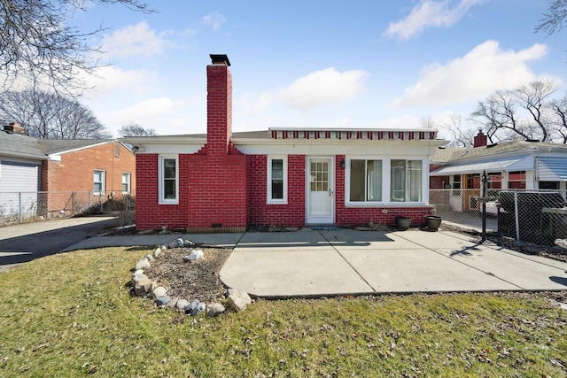 rear view of house featuring brick siding, crawl space, a chimney, and fence