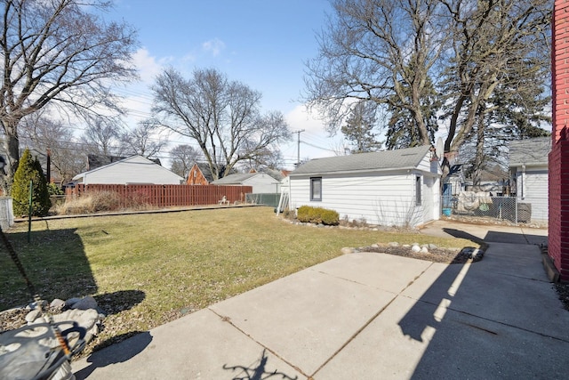 view of yard with an outdoor structure, a patio, and fence