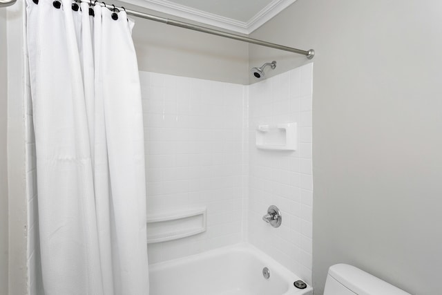 bathroom featuring toilet, crown molding, and shower / tub combo with curtain