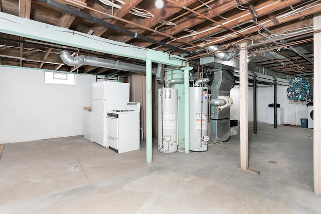 basement with water heater, freestanding refrigerator, and washer and dryer