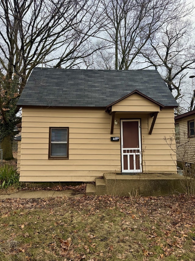 bungalow-style house with a shingled roof