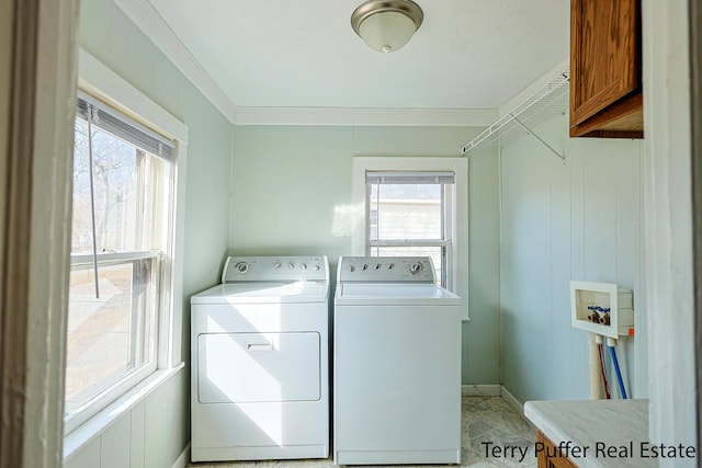 washroom with washer and dryer, cabinet space, wooden walls, and crown molding