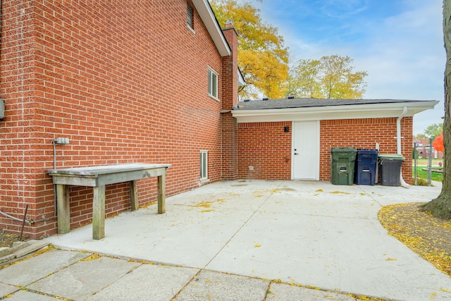 view of home's exterior featuring brick siding and a patio area