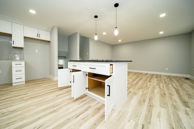 kitchen featuring light wood-style flooring, recessed lighting, baseboards, white cabinets, and pendant lighting