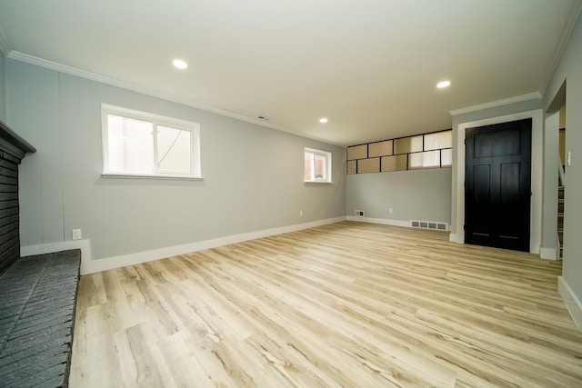 unfurnished living room featuring crown molding, baseboards, and wood finished floors