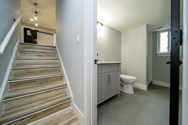 staircase with visible vents and baseboards