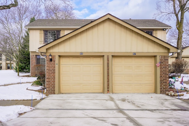 view of front of home with a garage and brick siding