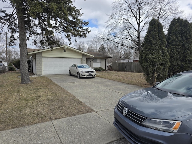 view of front of property featuring brick siding, concrete driveway, fence, a garage, and a front lawn