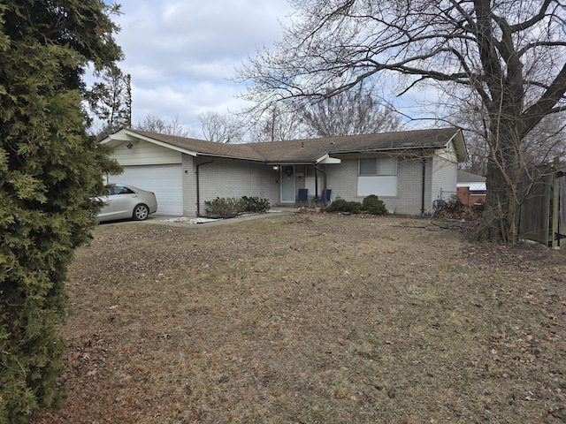 ranch-style house with a garage and brick siding