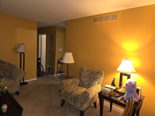 sitting room featuring baseboards, visible vents, and carpet flooring