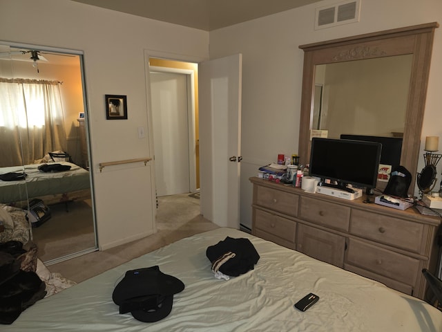 bedroom featuring light colored carpet and visible vents