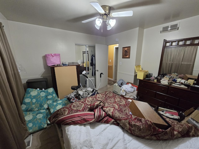 bedroom featuring ceiling fan, a closet, and visible vents