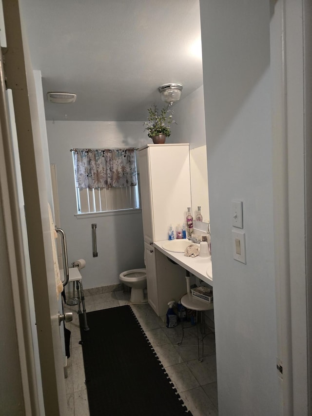 bathroom with toilet, visible vents, and vanity