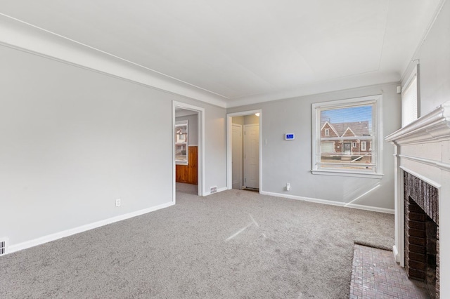 unfurnished living room featuring baseboards, carpet floors, and a brick fireplace