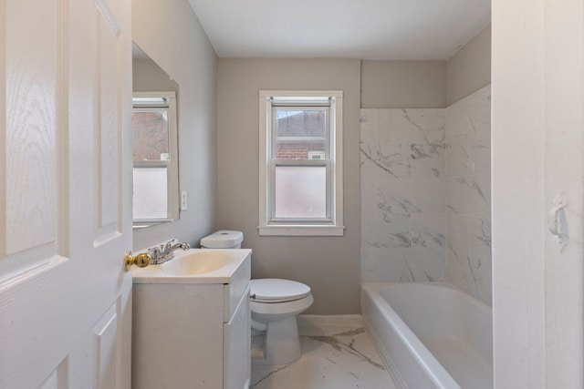 bathroom featuring a wealth of natural light, marble finish floor, toilet, and vanity