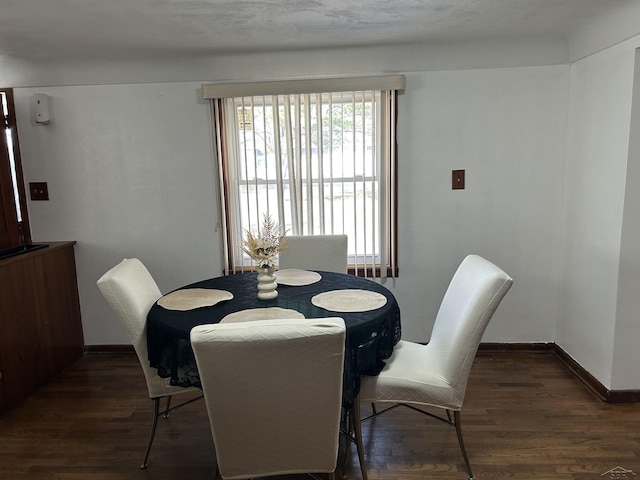 dining area featuring baseboards and wood finished floors