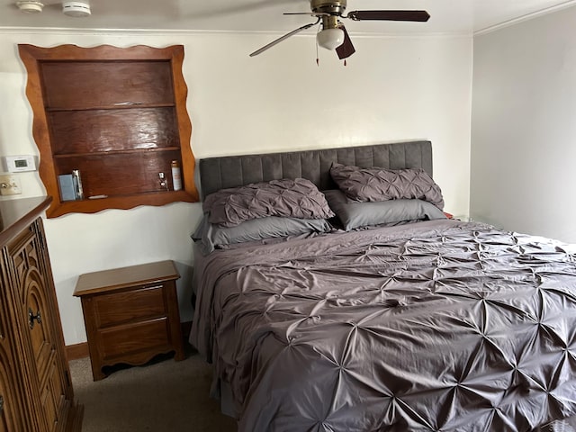 carpeted bedroom with crown molding and ceiling fan