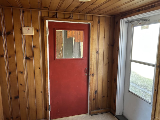 doorway with wooden walls and wood ceiling