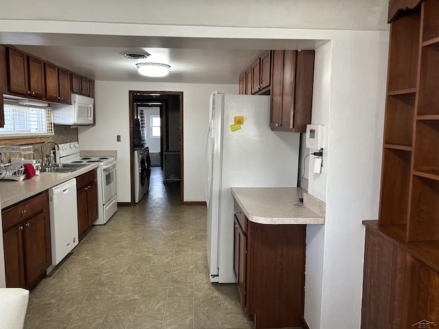 kitchen featuring white appliances, light floors, visible vents, a sink, and light countertops