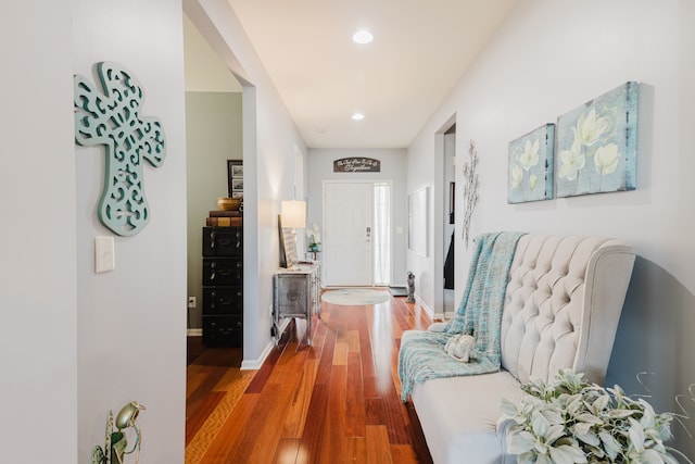 corridor with recessed lighting, wood finished floors, and baseboards