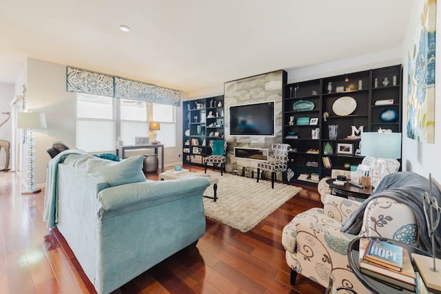 living room with built in shelves and wood finished floors