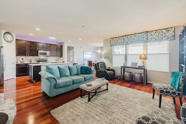 living area with hardwood / wood-style floors and recessed lighting