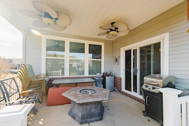 view of patio with area for grilling, a fire pit, and ceiling fan