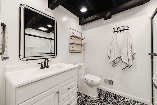 bathroom with vanity, baseboards, visible vents, walk in shower, and toilet