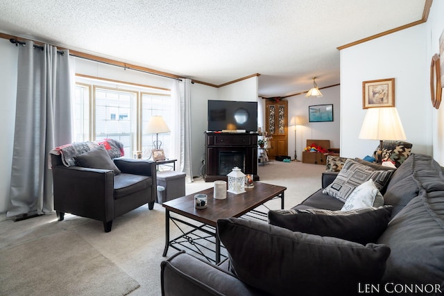 living room with light carpet, a textured ceiling, a glass covered fireplace, and crown molding