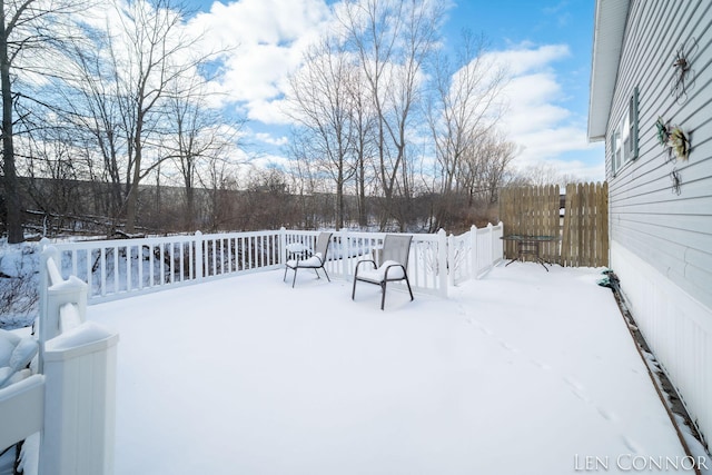 snowy yard with fence