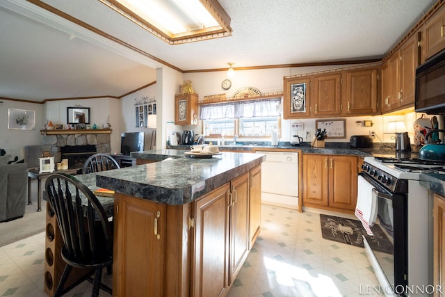 kitchen with black microwave, electric range oven, dishwasher, light floors, and dark countertops