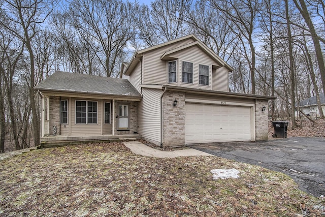 view of front facade featuring brick siding, driveway, an attached garage, and roof with shingles