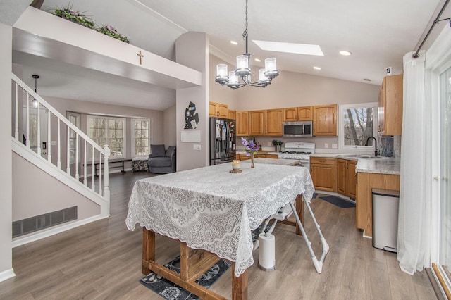 dining area featuring a wealth of natural light, visible vents, light wood-style flooring, and stairs