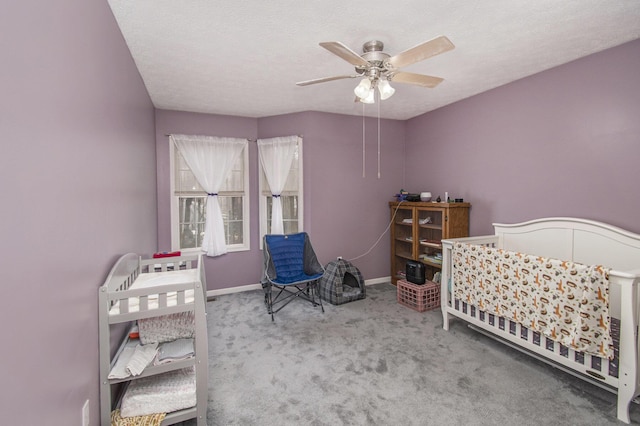 bedroom featuring carpet flooring, ceiling fan, a textured ceiling, and baseboards