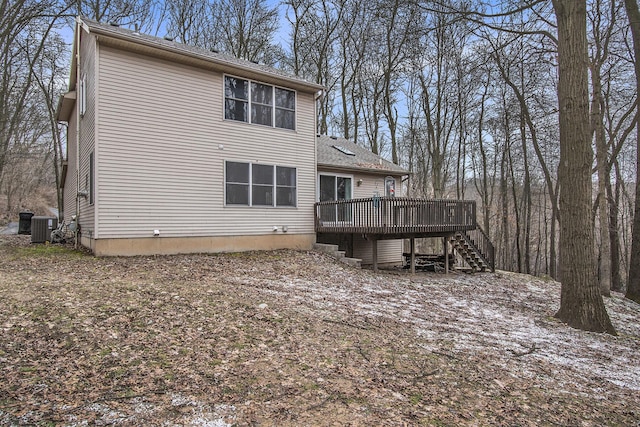 back of property featuring stairway, central AC, and a wooden deck