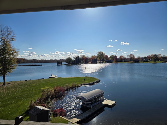 view of water feature with boat lift and a dock