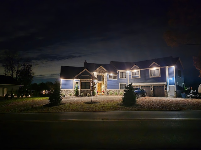 view of front of house featuring a garage and stone siding