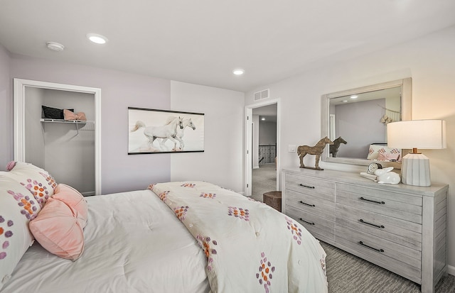 carpeted bedroom with recessed lighting, visible vents, and a closet