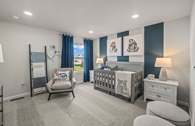 bedroom featuring visible vents, baseboards, and light colored carpet