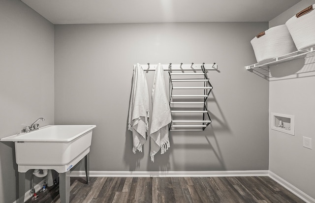 washroom featuring baseboards, wood finished floors, hookup for a washing machine, and laundry area