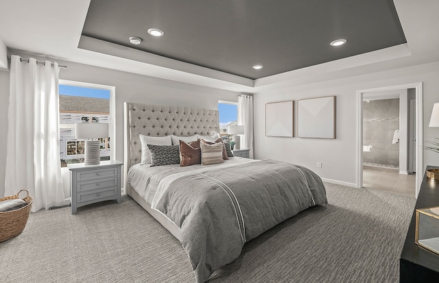 bedroom with recessed lighting, baseboards, a raised ceiling, and light carpet