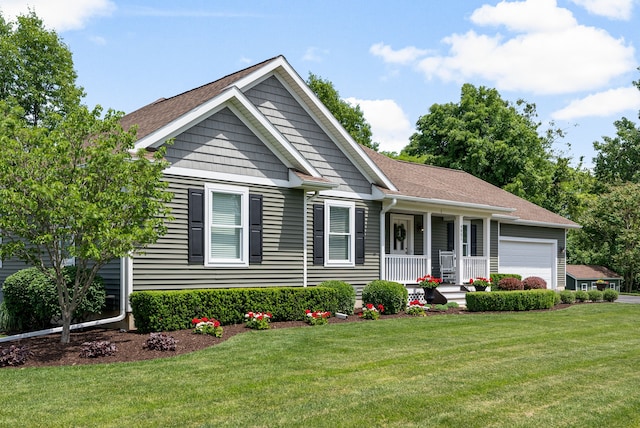 view of front of property with a front yard, a porch, and an attached garage