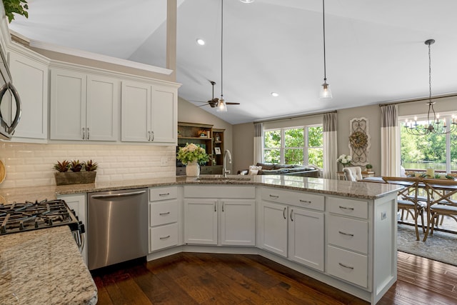 kitchen featuring dishwasher, vaulted ceiling, a peninsula, white cabinets, and a sink