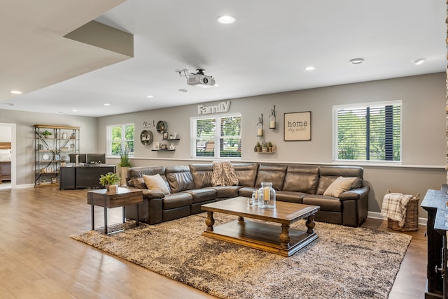 living room with recessed lighting, baseboards, plenty of natural light, and wood finished floors