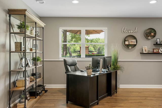 office space with recessed lighting, wood finished floors, and baseboards