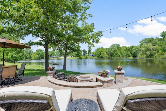 view of patio / terrace featuring a fire pit, a water view, and grilling area