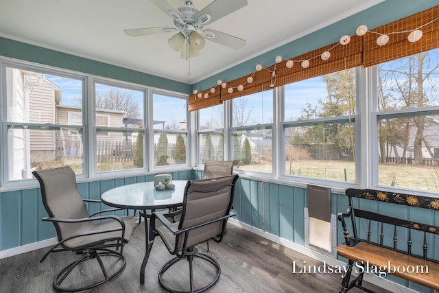 sunroom / solarium with a ceiling fan and a healthy amount of sunlight