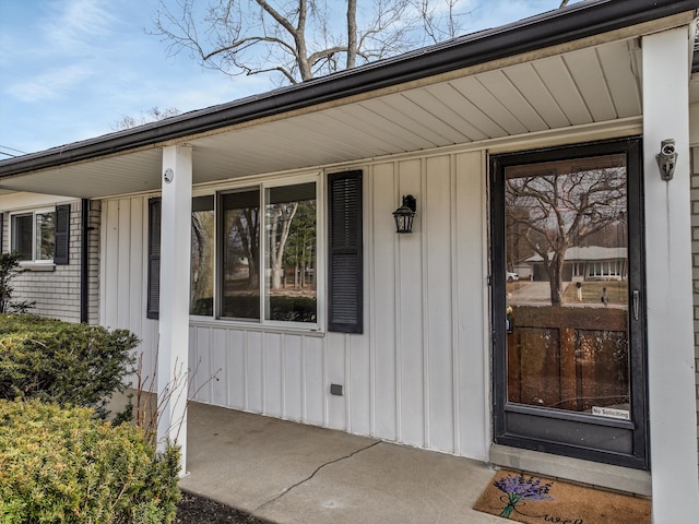 doorway to property featuring board and batten siding