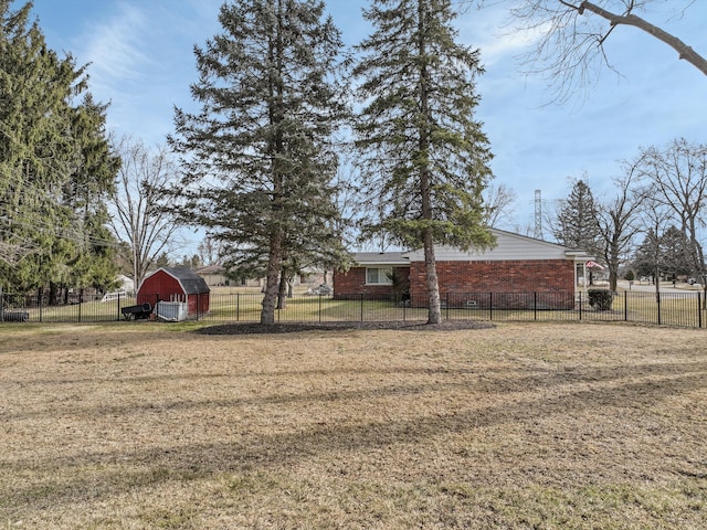 view of yard featuring an outdoor structure and fence